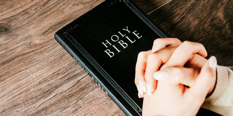 Praying Hands on a Bible